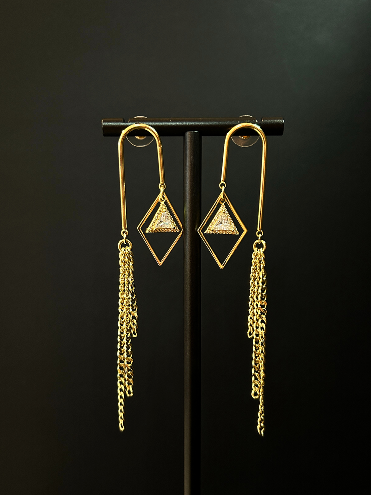 DIPHDA Cosmic Waterfall Earrings with cubic zirconia triangle charms and gold chain fringe, displayed against a celestial backdrop
